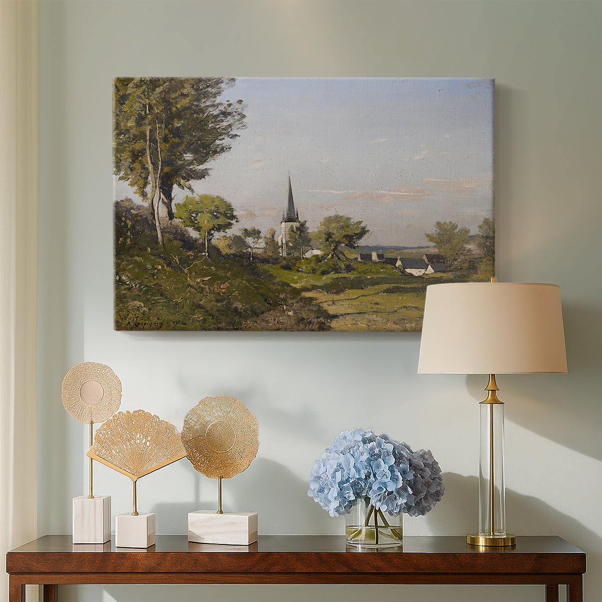 Canvas art print featuring a peaceful village landscape with architecture and nature, displayed above a styled console table