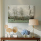 Canvas art print featuring a soft landscape with people and trees in calm setting, displayed above a styled console table