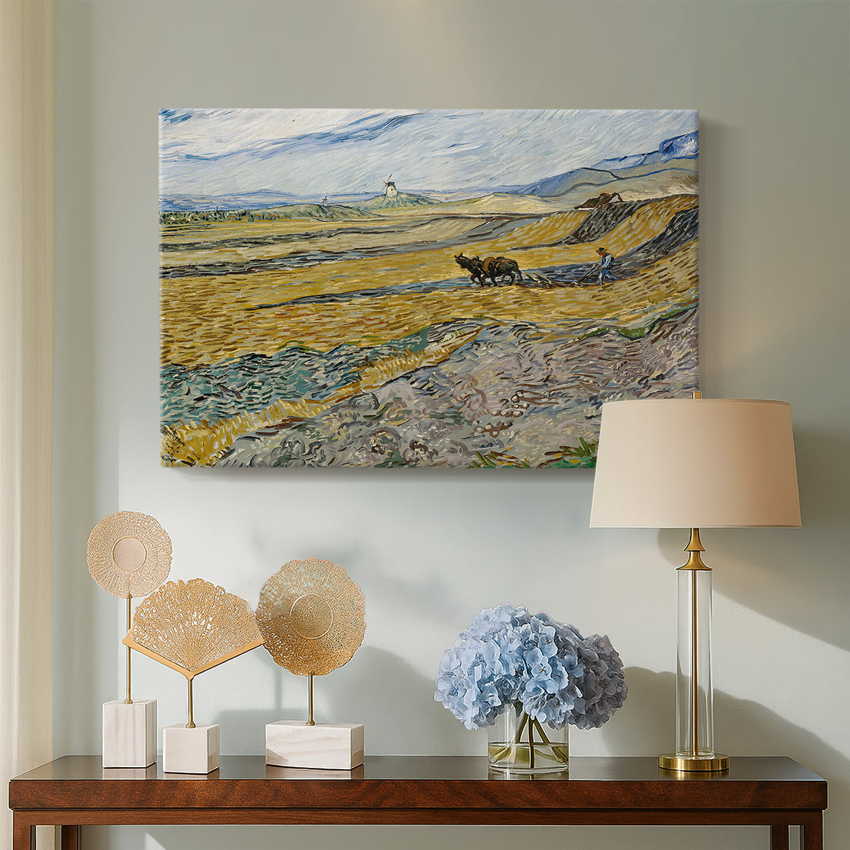 Canvas art print featuring a post-impressionist farm scene with cultivated land and open horizon, displayed above a styled console table