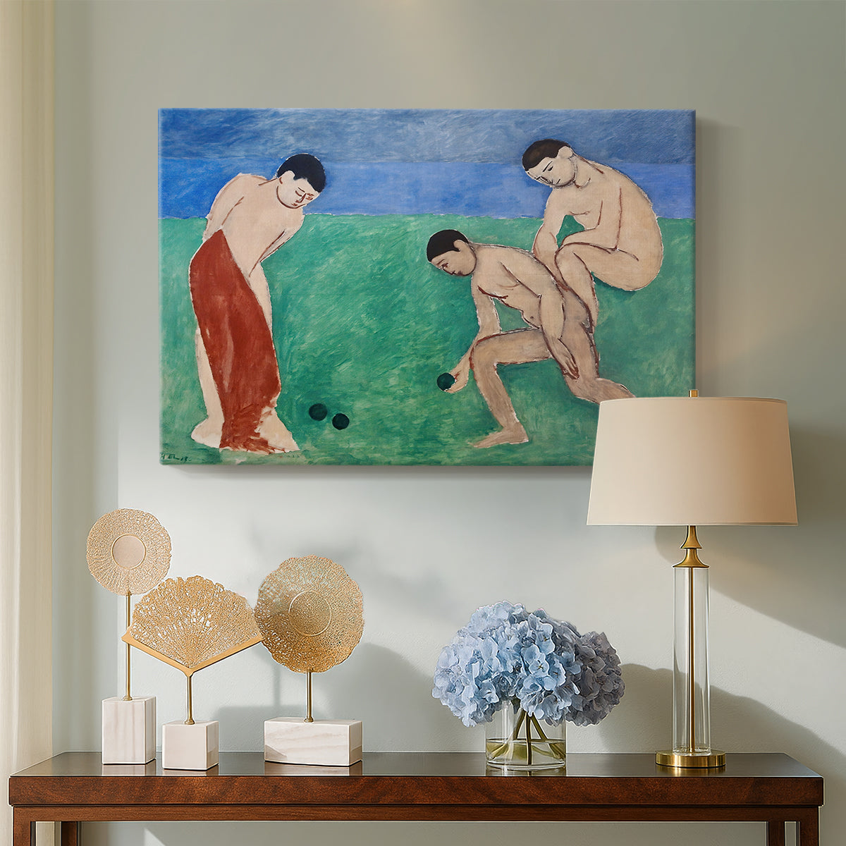 Canvas art print featuring a stylized figures interacting in a bright open field, displayed above a styled console table