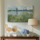 Canvas art print featuring a tranquil riverside scene with houses and vegetation, displayed above a styled console table