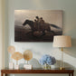 Canvas art print featuring a narrative painting of escape and urgency across rugged terrain, displayed above a styled console table