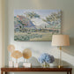 Canvas art print featuring a rural composition with houses and greenery, displayed above a styled console table