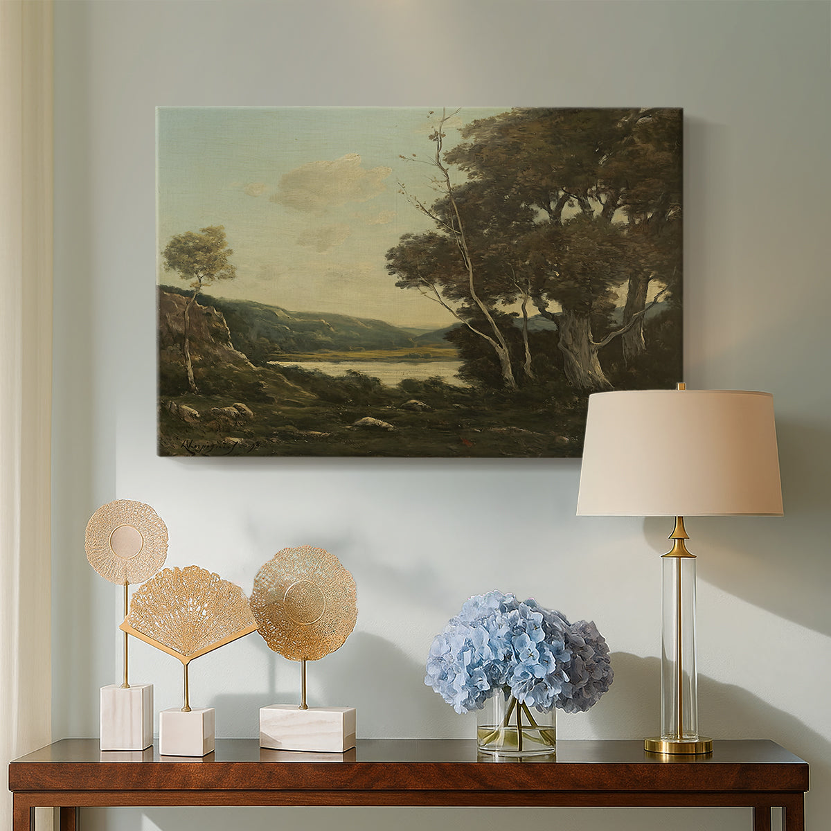 Canvas art print featuring a rural landscape with trees and open space, displayed above a styled console table