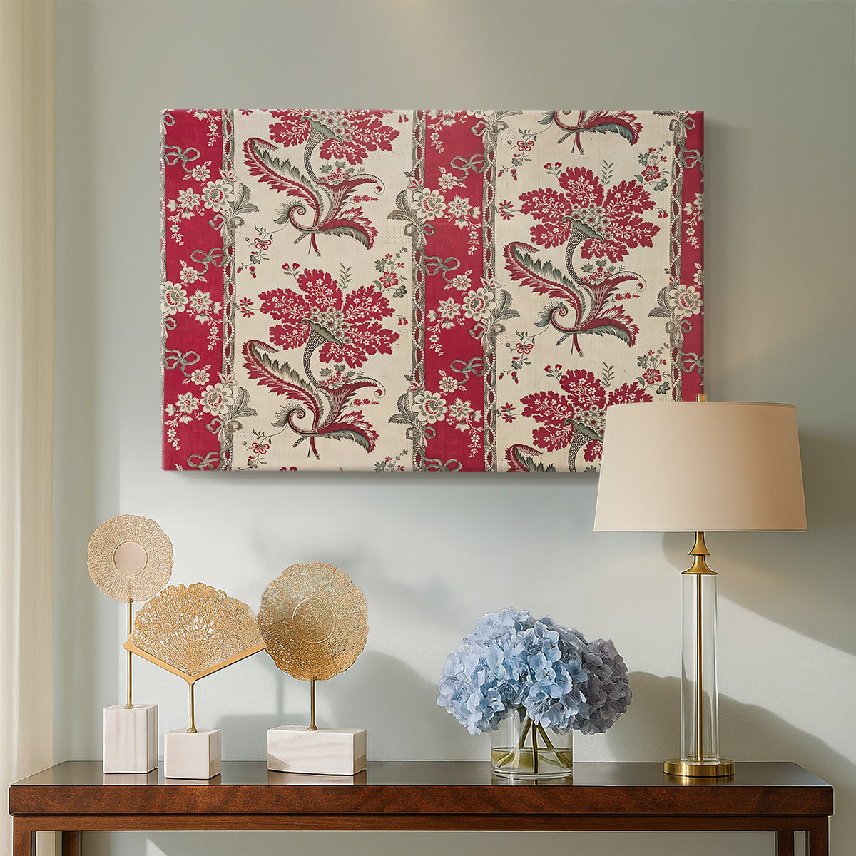 Canvas art print featuring a decorative composition featuring repeated botanical groupings, displayed above a styled console table