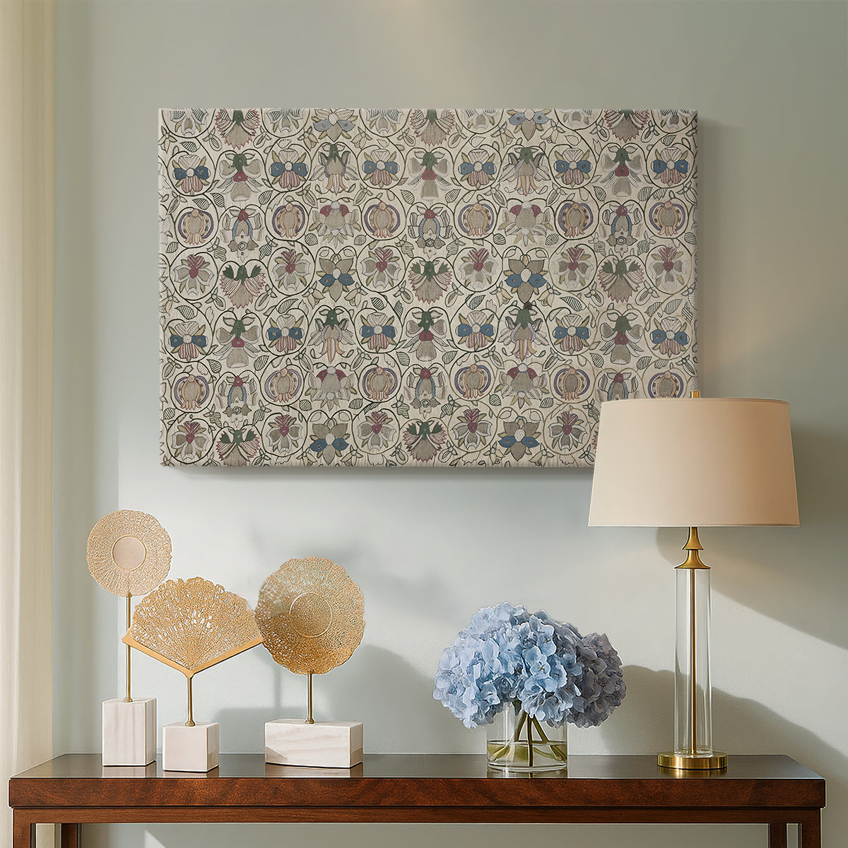 Canvas art print featuring a patterned textile featuring repeated flowers and leaves, displayed above a styled console table