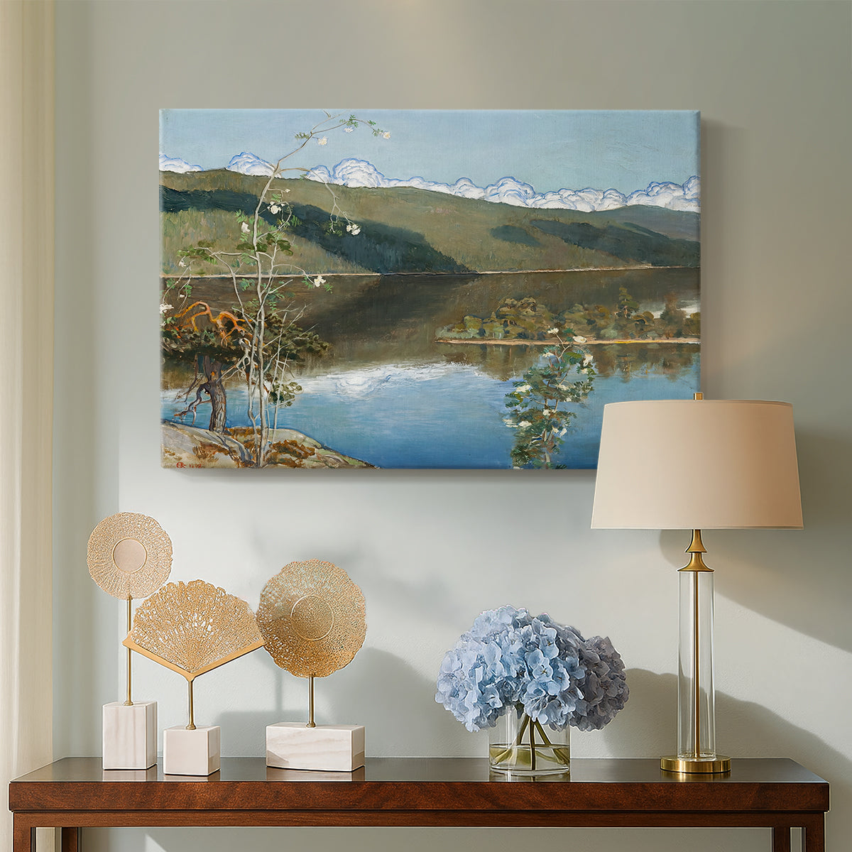 Canvas art print featuring an expansive view of land and water beneath approaching storm clouds, displayed above a styled console table