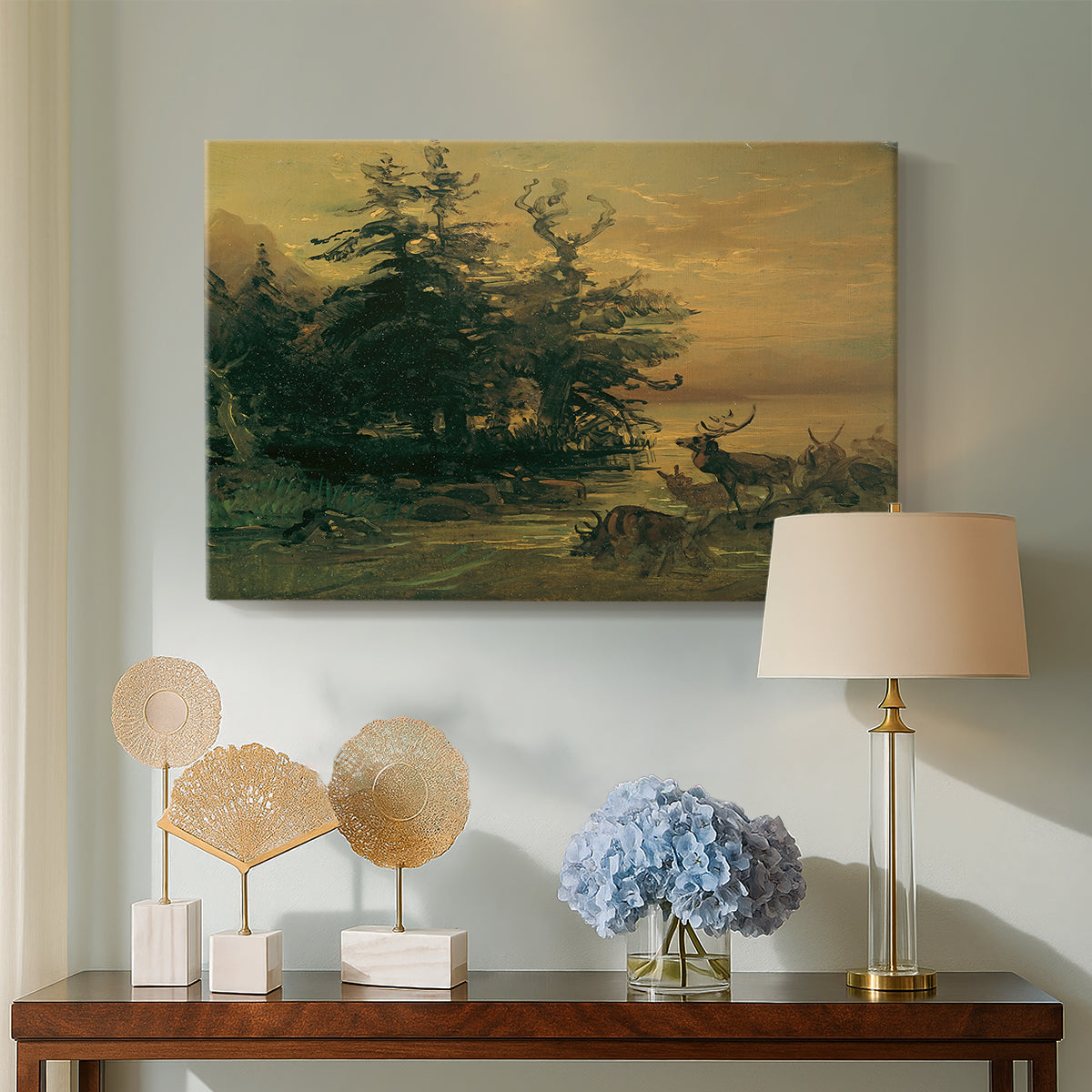 Canvas art print featuring an alpine landscape with deer, displayed above a styled console table