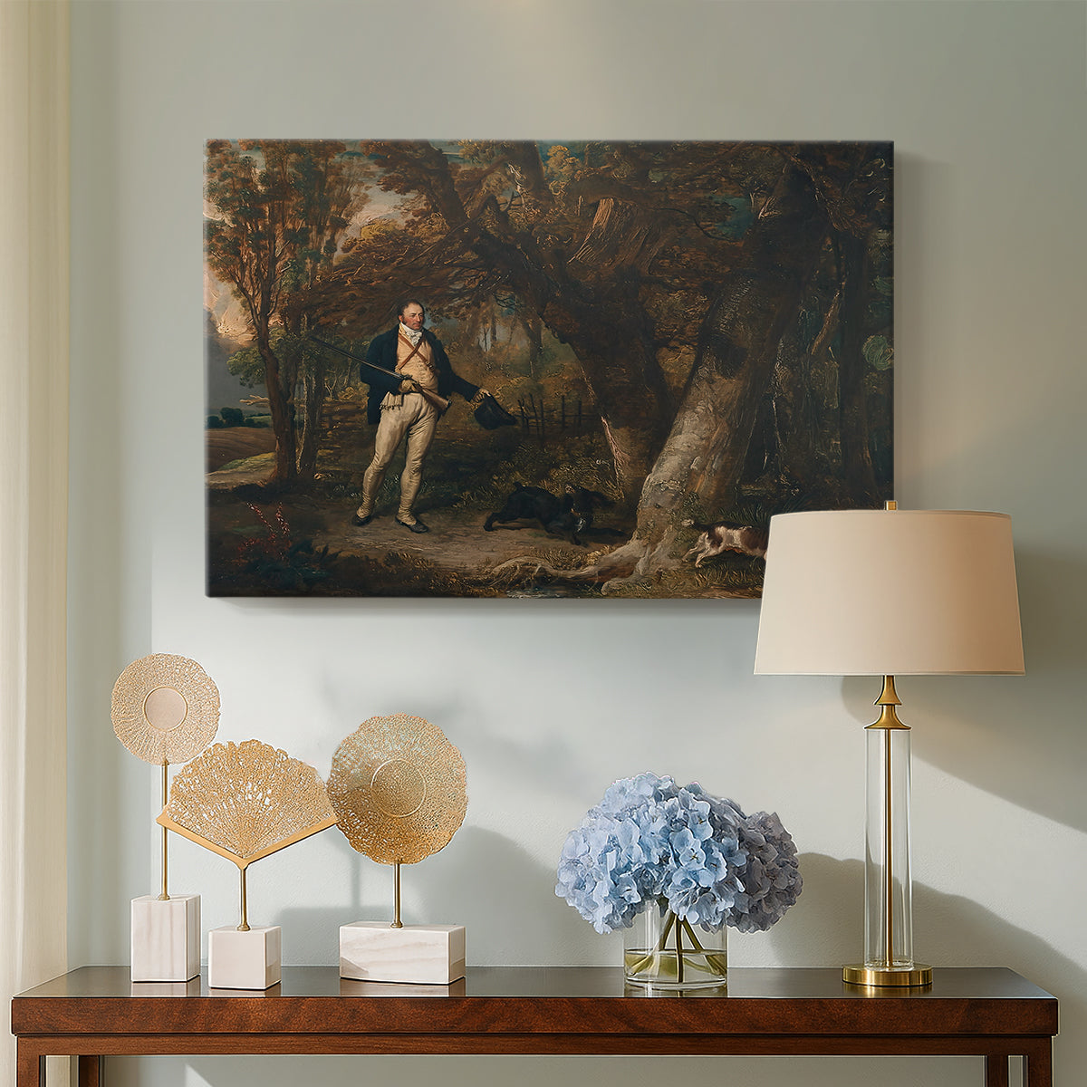 Canvas art print featuring a rural composition featuring hunter and animals, displayed above a styled console table
