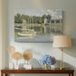 Canvas art print featuring a bright landscape featuring bridge and sailboats on calm water, displayed above a styled console table