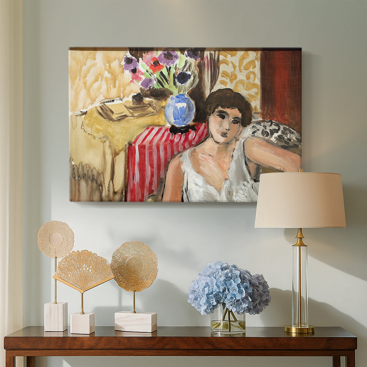 Canvas art print featuring an expressive seated figure with furnishings, displayed above a styled console table