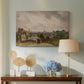 Canvas art print featuring a countryside scene with cottage, displayed above a styled console table