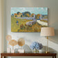 Canvas art print featuring a countryside composition with house and open terrain, displayed above a styled console table