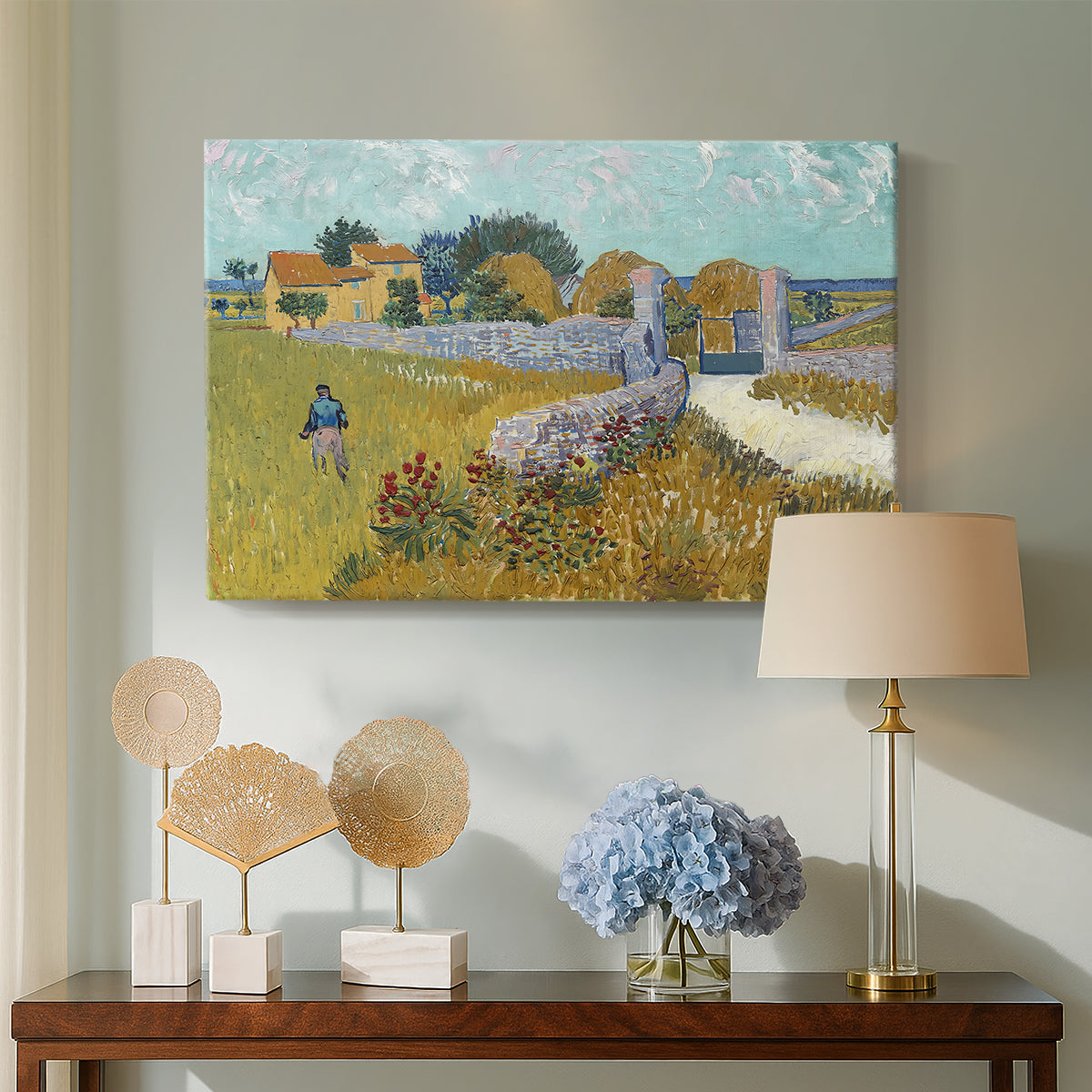 Canvas art print featuring a countryside composition with house and open terrain, displayed above a styled console table