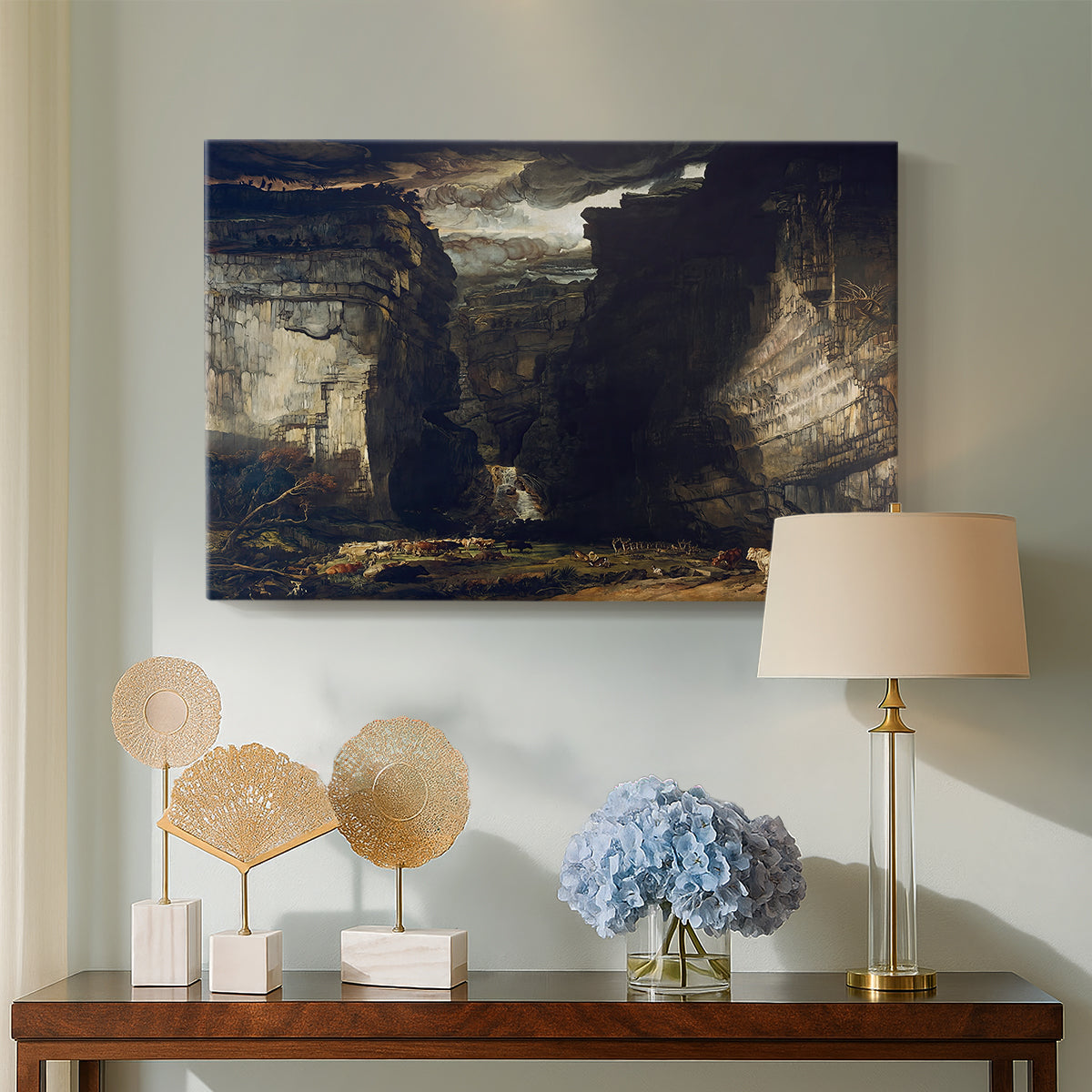 Canvas art print featuring a natural scene featuring cliffs and cascading water, displayed above a styled console table