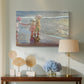 Canvas art print featuring an impressionist scene with women and ocean backdrop, displayed above a styled console table