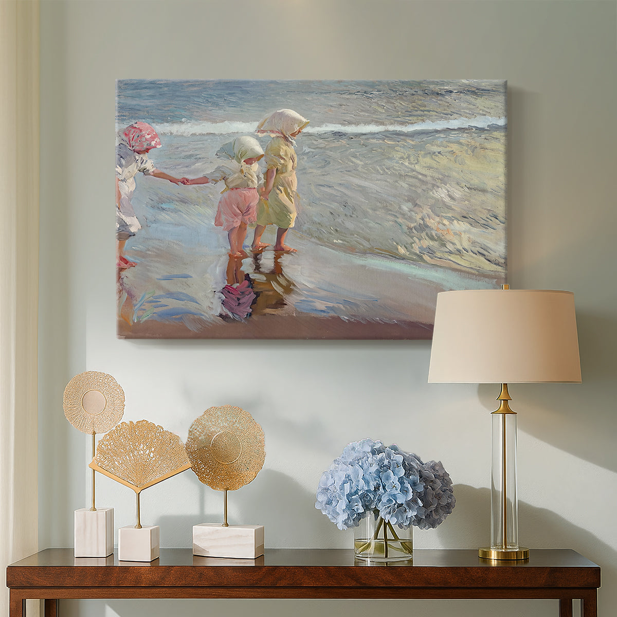Canvas art print featuring an impressionist scene with women and ocean backdrop, displayed above a styled console table