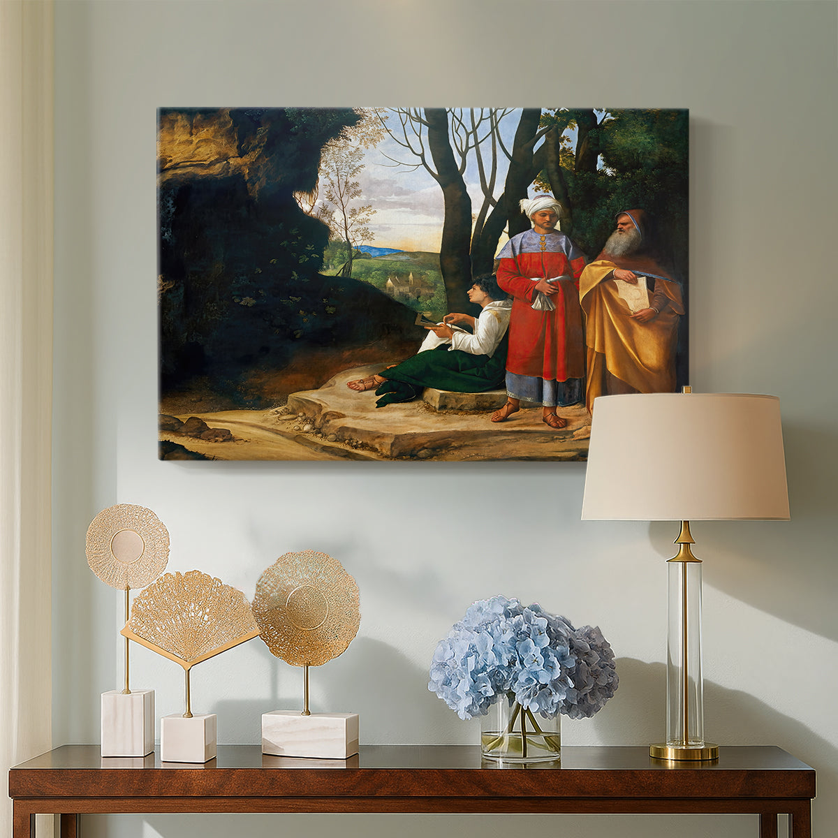 Canvas art print featuring a group of men posed near rocky terrain with distant landscape, displayed above a styled console table