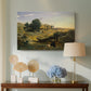 Canvas art print featuring an atmospheric landscape with lone figure and open space, displayed above a styled console table