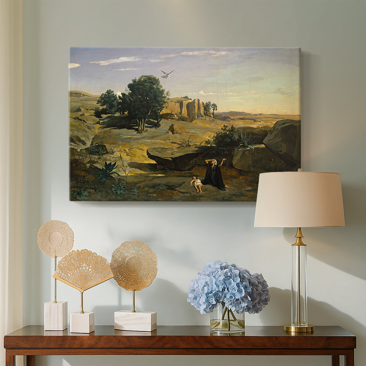 Canvas art print featuring an atmospheric landscape with lone figure and open space, displayed above a styled console table