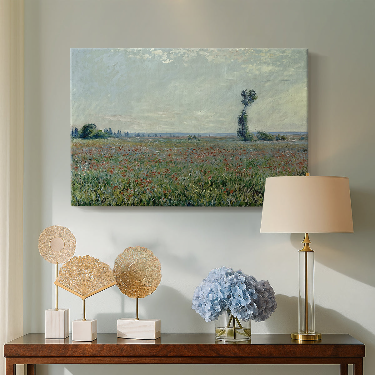 Canvas art print featuring a rural meadow with scattered poppies and soft horizon, displayed above a styled console table