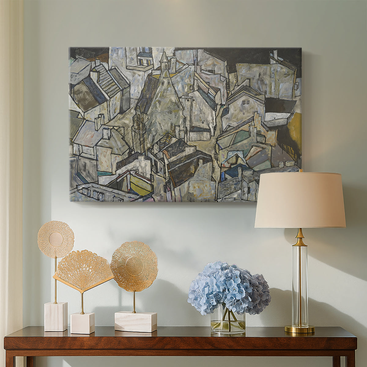 Canvas art print featuring an abstracted town view with angular rooftops and fragmented forms, displayed above a styled console table