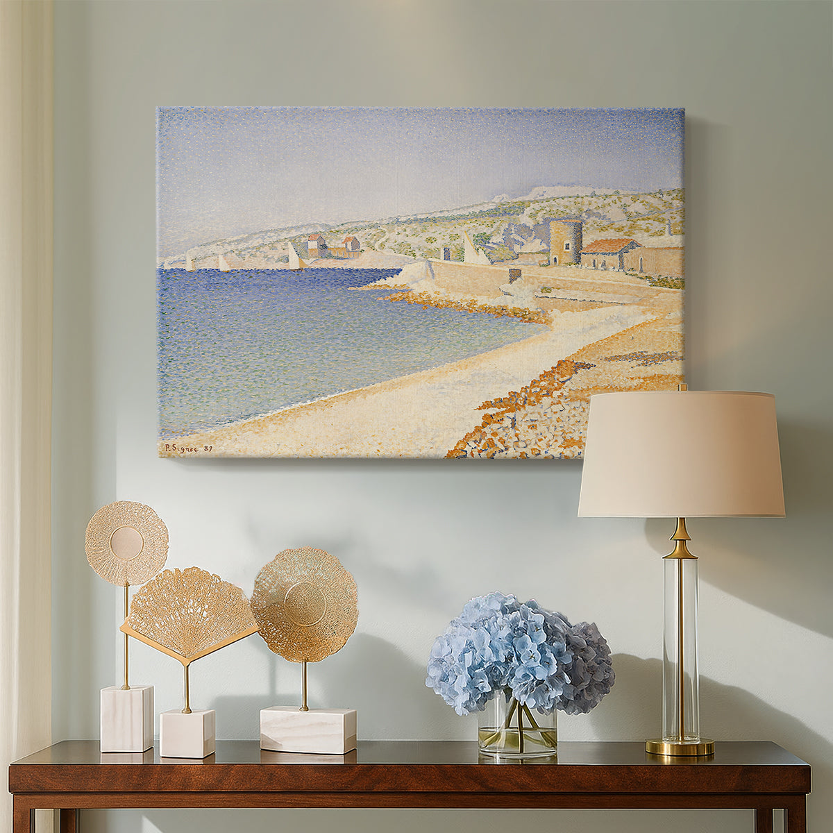 Canvas art print featuring a pointillist coastal composition, displayed above a styled console table