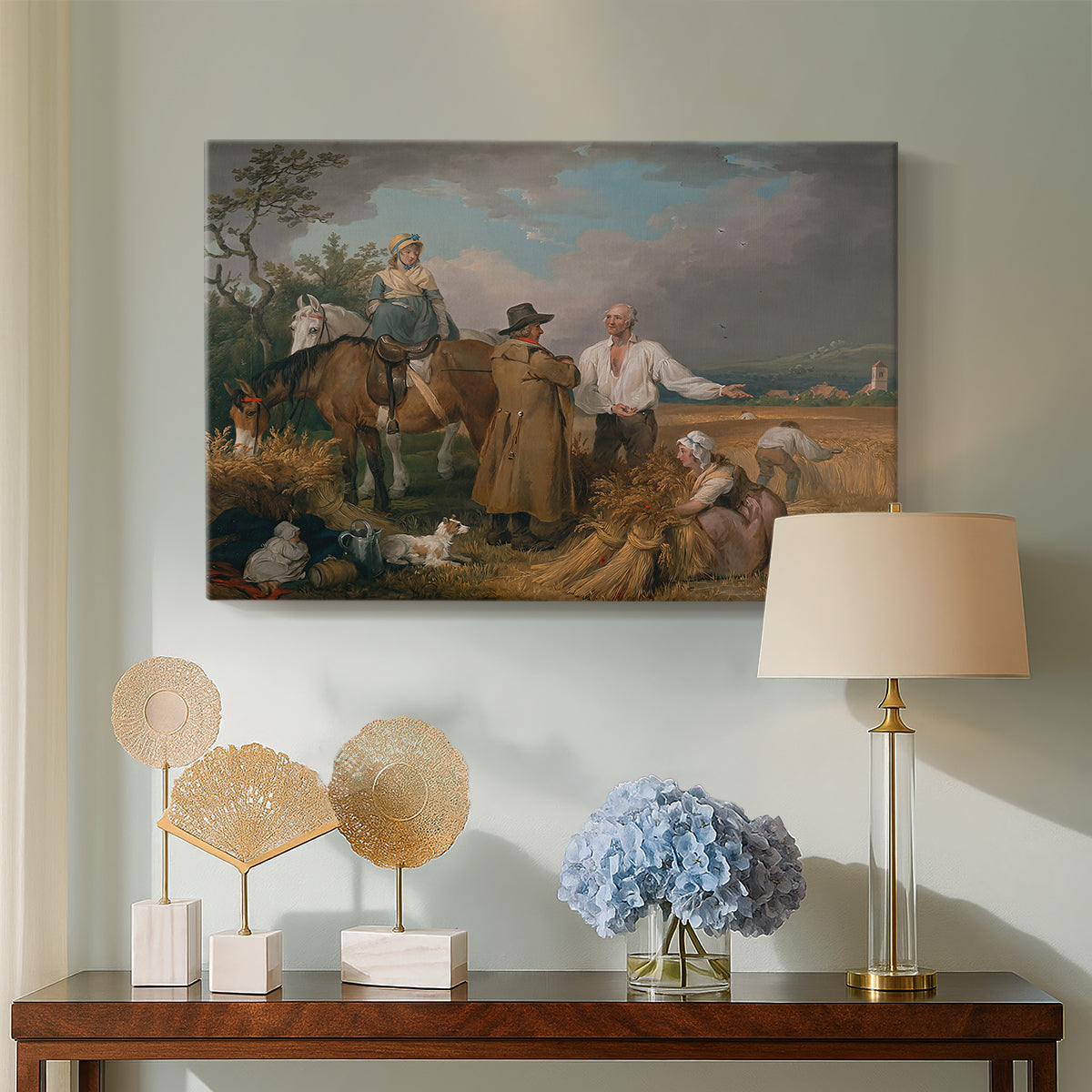 Canvas art print featuring countryside activity with figures engaged in harvest, displayed above a styled console table