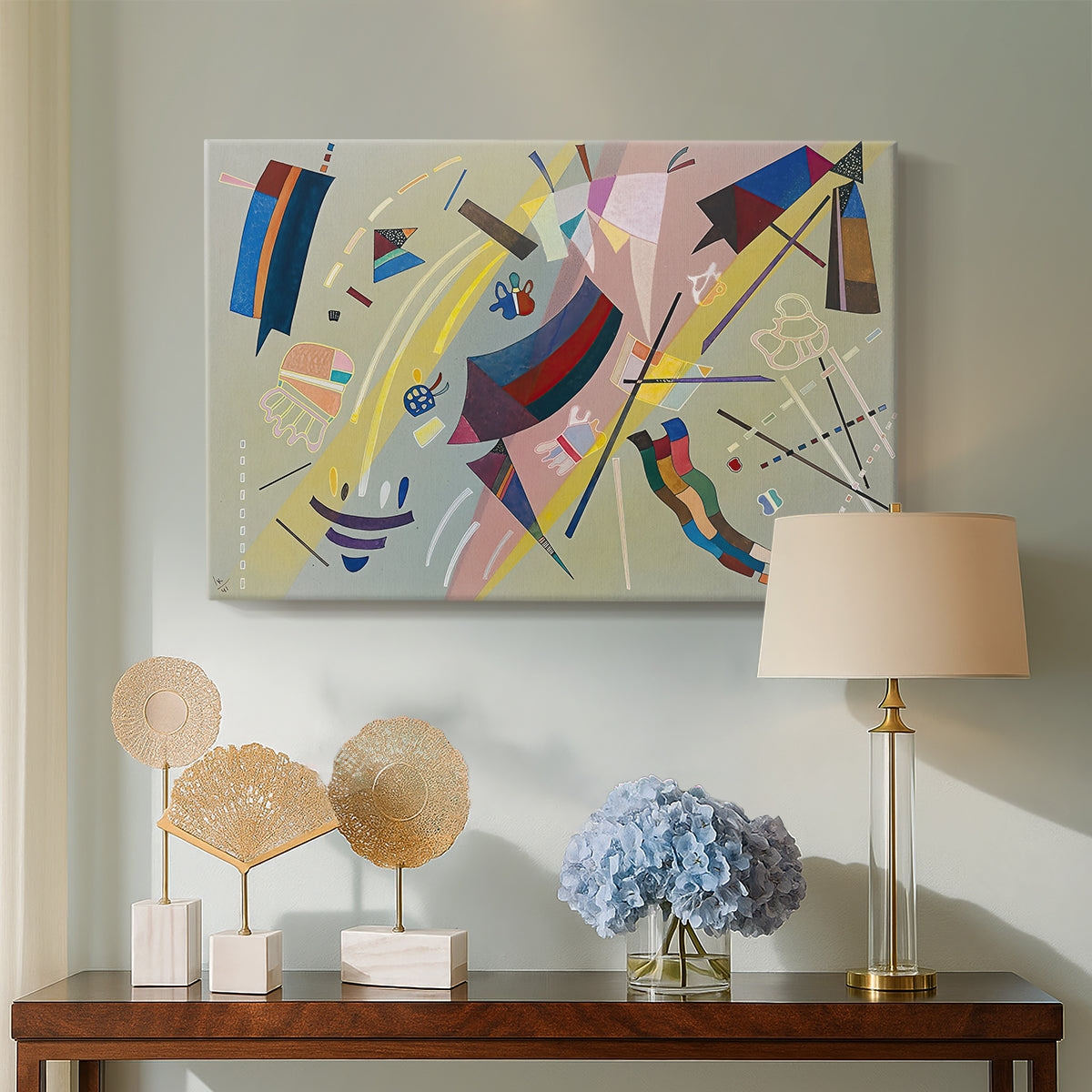 Canvas art print featuring an abstract arrangement combining linear elements and color accents, displayed above a styled console table