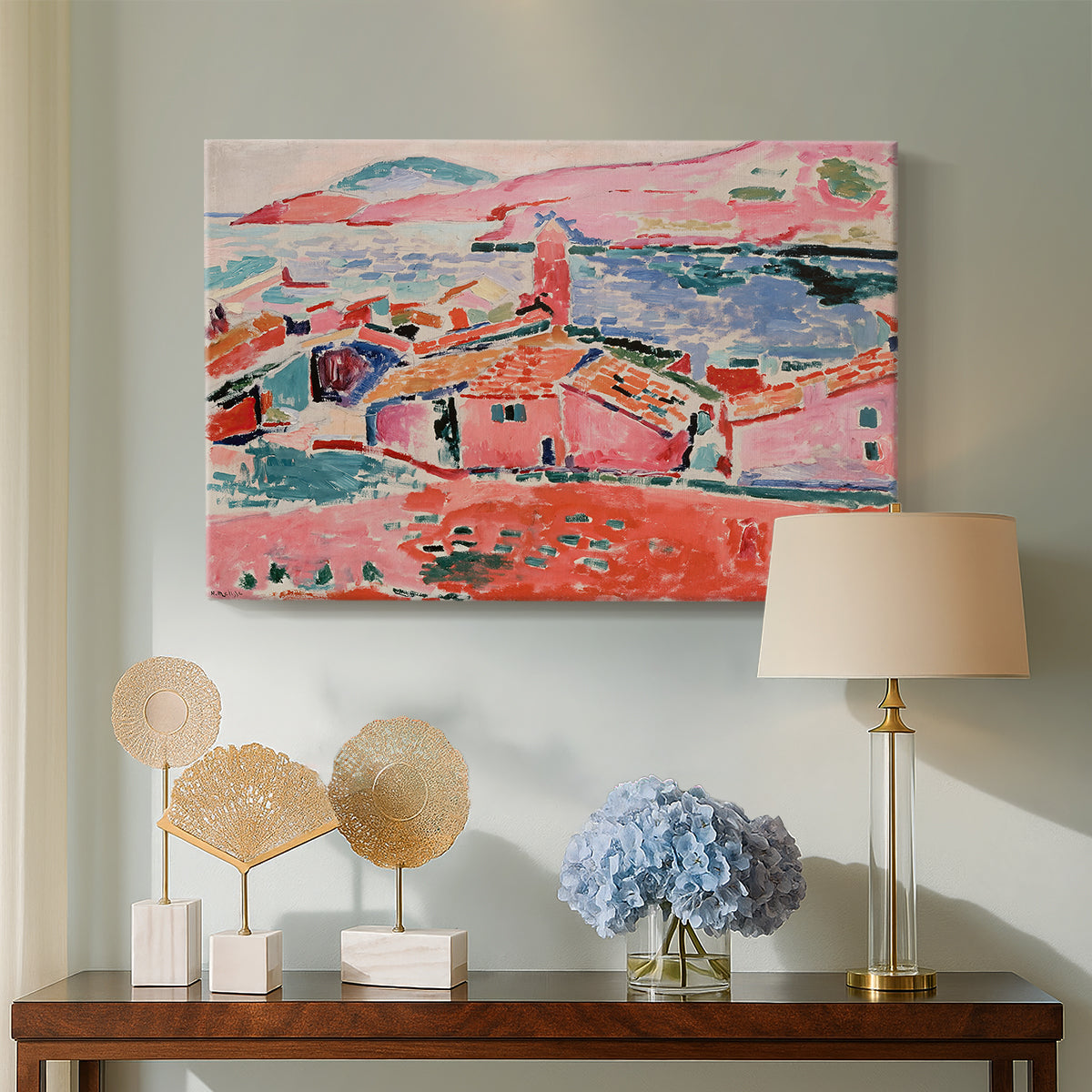 Canvas art print featuring a Fauvist cityscape of a seaside town in vivid tones, displayed above a styled console table
