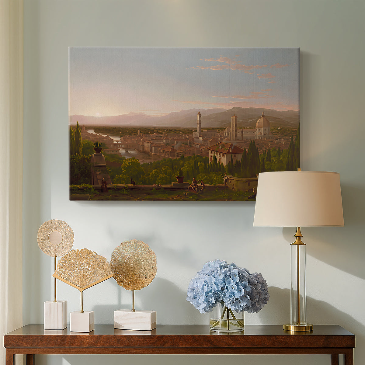 Canvas art print featuring a romantic cityscape integrated into natural terrain, displayed above a styled console table