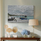 Canvas art print featuring a coastal landscape with sailboats and visitors on cliffside, displayed above a styled console table