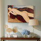 Canvas art print featuring a modernist nude figure lying face down with simplified contours, displayed above a styled console table