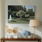 Canvas art print featuring an elegant woman posed outdoors among blooming plants, displayed above a styled console table