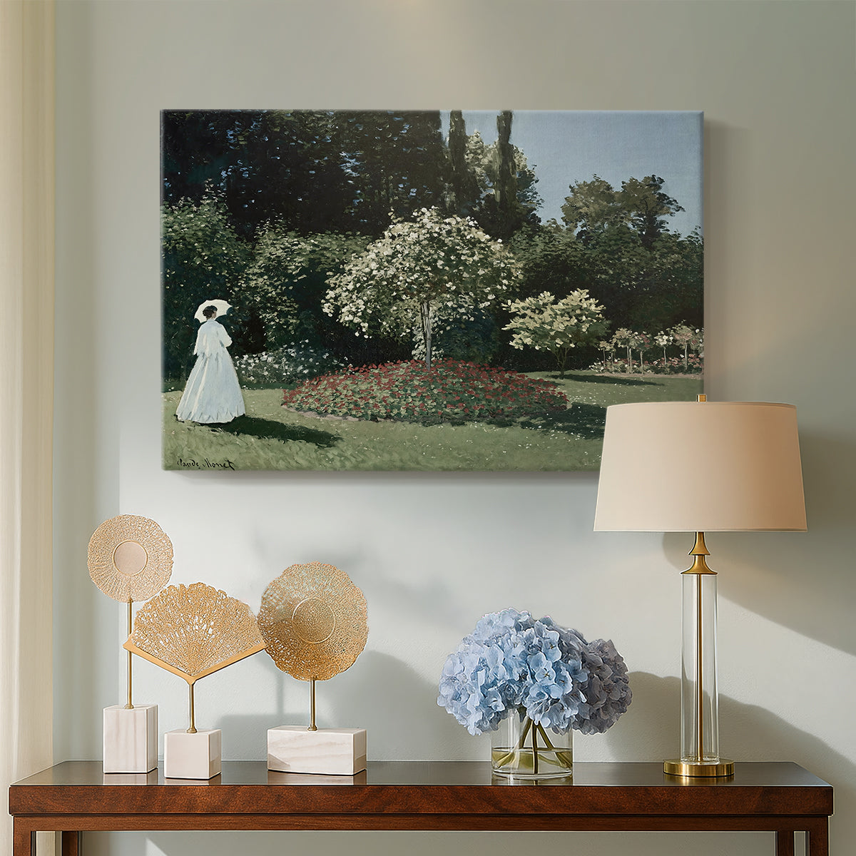 Canvas art print featuring an elegant woman posed outdoors among blooming plants, displayed above a styled console table