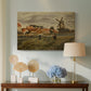 Canvas art print featuring a countryside composition with houses and working figures, displayed above a styled console table