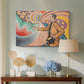 Canvas art print featuring an expressive figure with ornamental design, displayed above a styled console table