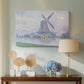 Canvas art print featuring a countryside view with windmill, displayed above a styled console table