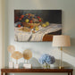 Canvas art print featuring a close-up of apples and grapes in warm tones, displayed above a styled console table