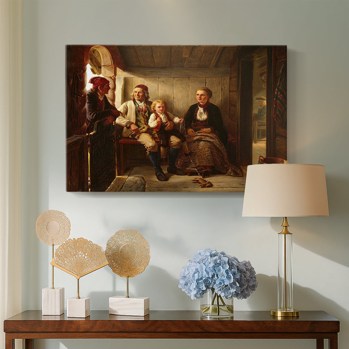 Canvas art print featuring a traditional village interior with figures engaged in conversation by candlelight, displayed above a styled console table