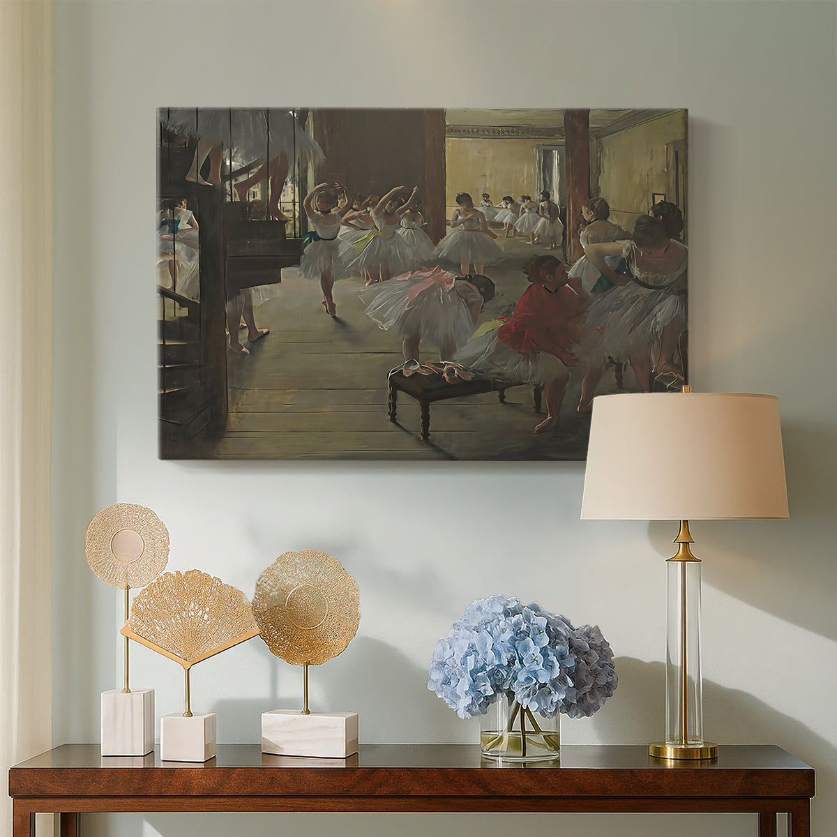 Canvas art print featuring an impressionist studio interior filled with ballet students, displayed above a styled console table
