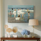 Canvas art print featuring an impressionist coastal view of families enjoying seaside water, displayed above a styled console table