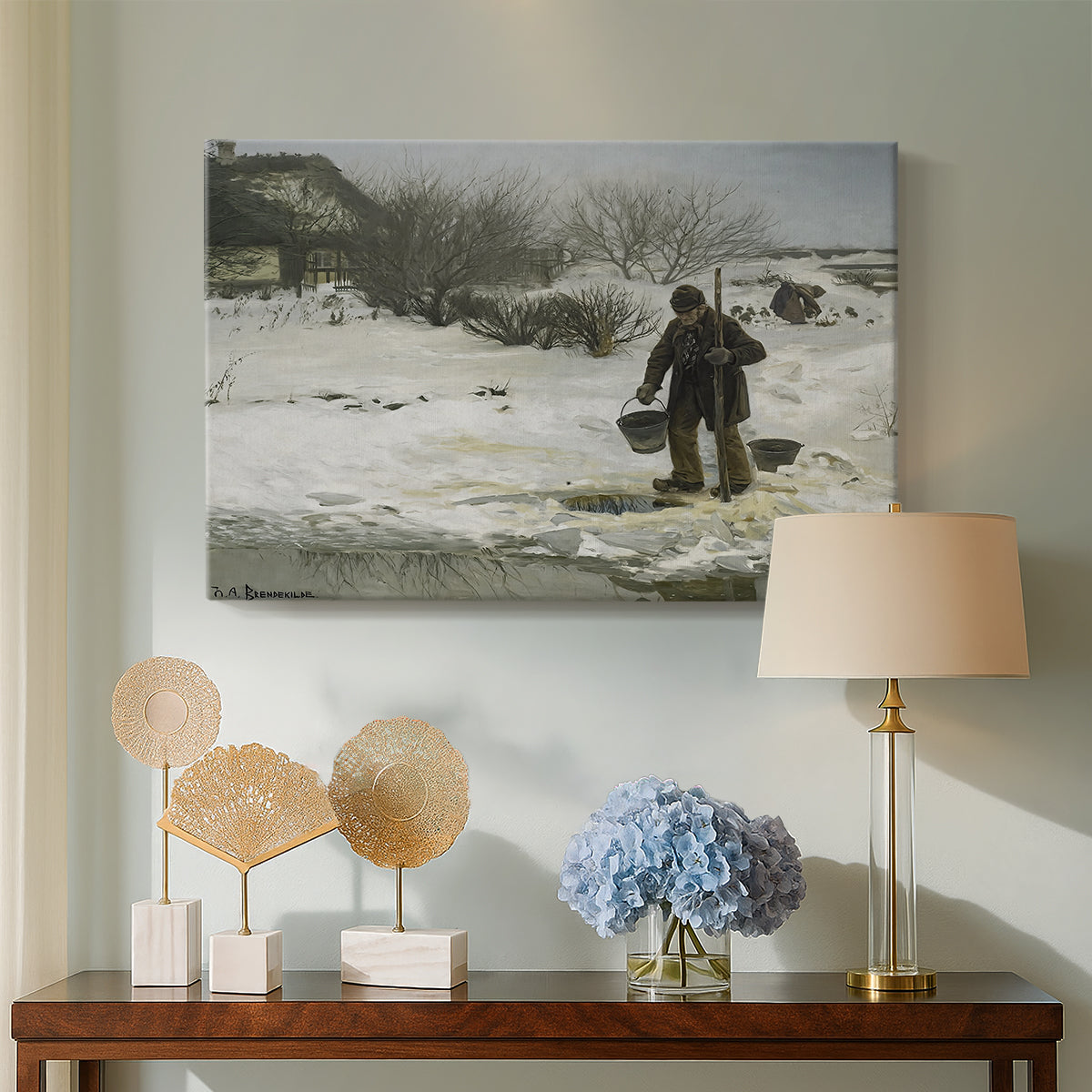 Canvas art print featuring a figures moving through open snowy terrain under gray sky, displayed above a styled console table