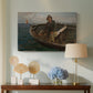 Canvas art print featuring a coastal activity with fishermen in traditional setting, displayed above a styled console table