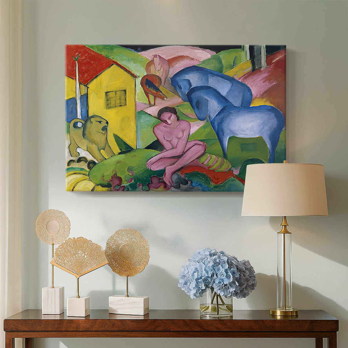 Canvas art print featuring a surreal arrangement of figures and animals in bright palette, displayed above a styled console table