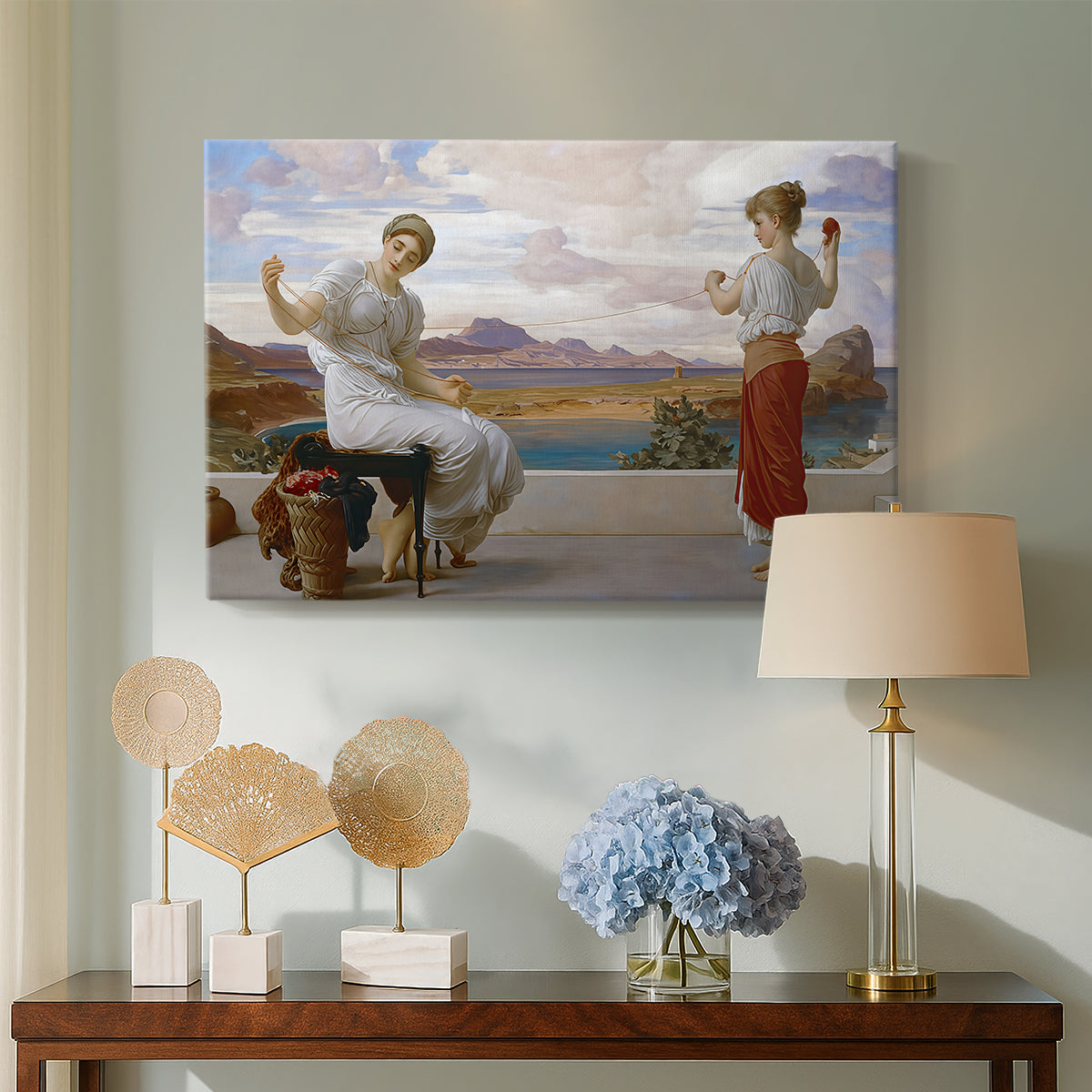 Canvas art print featuring a classical scene of figures winding thread together, displayed above a styled console table
