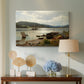Canvas art print featuring a coastal landscape with figures engaged in daily activity, displayed above a styled console table
