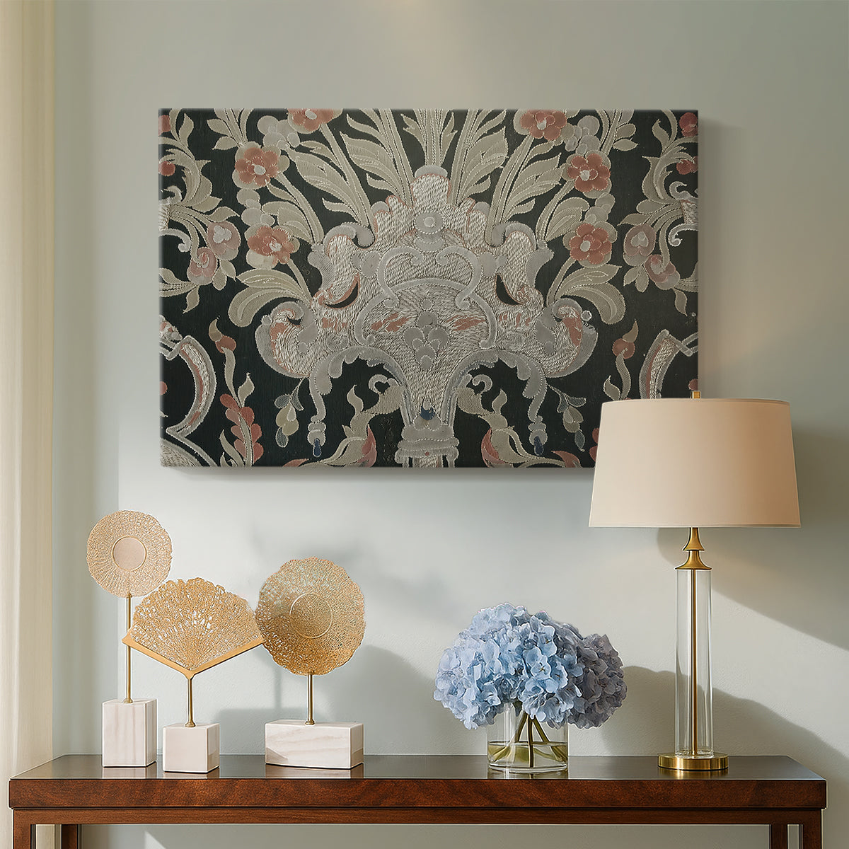 Canvas art print featuring an ornamental composition with layered motifs and repeating figures, displayed above a styled console table