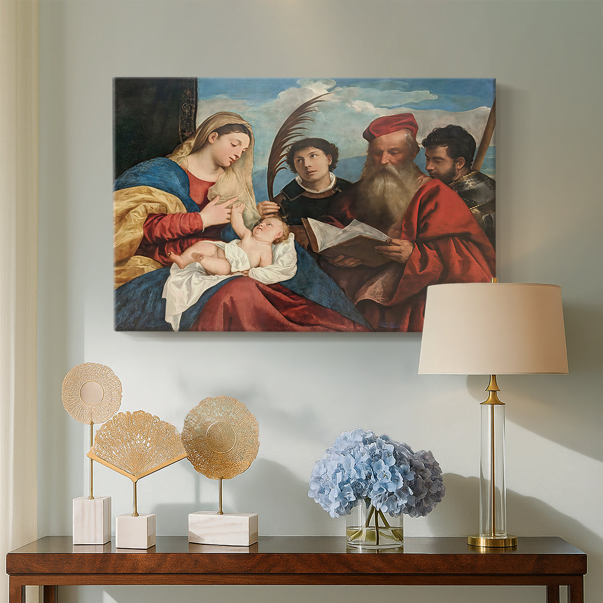 Canvas art print featuring a Renaissance group portrait of sacred figures in close arrangement, displayed above a styled console table