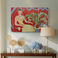 Canvas art print featuring a stylized seated female figure in strong warm tones, displayed above a styled console table